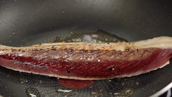 Using tongs, flip the fillet over and saute on each side.