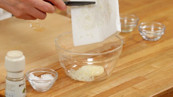 Place the onion onto a paper towel and remove the excess moisture. Then, add the onion to a bowl with the mayonnaise.