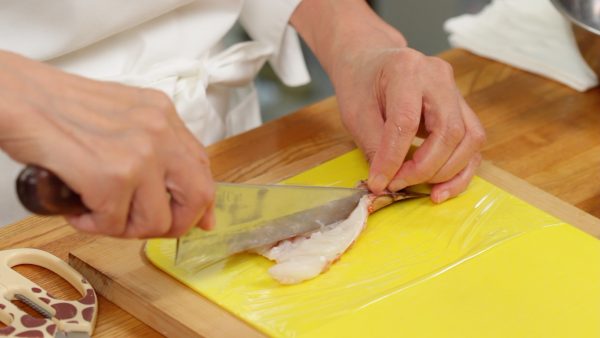 With kitchen shears, make a cut along the last shell segment and open that section too.