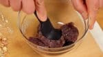 Next, combine the black sesame paste and anko, sweet red bean paste in a bowl. Thoroughly mix the paste.