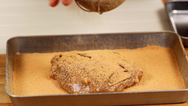 Sprinkle on the kinako and flatten the mochi.