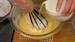 When the butter is completely combined, gradually add the milk.