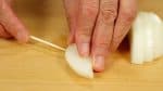 Slice the onion into 1cm (0.4") slices. From the outer layers, skewer the onion with a wooden pick.