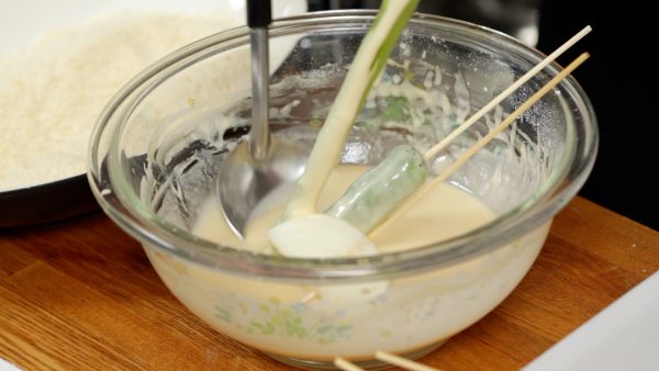 First, start with the vegetables. Coat each ingredient with the batter. Ladling the batter over the ingredients will help to coat them evenly. Drop off the excess batter.
