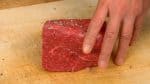 Remove the beef from the fridge 2 to 3 hours before cooking. Lightly sprinkle the salt over the entire surface of the bottom round roast. Likewise, sprinkle on the pepper. Bottom round is a relatively lean, inexpensive meat and the slices are often used for sukiyaki and shabu shabu.
