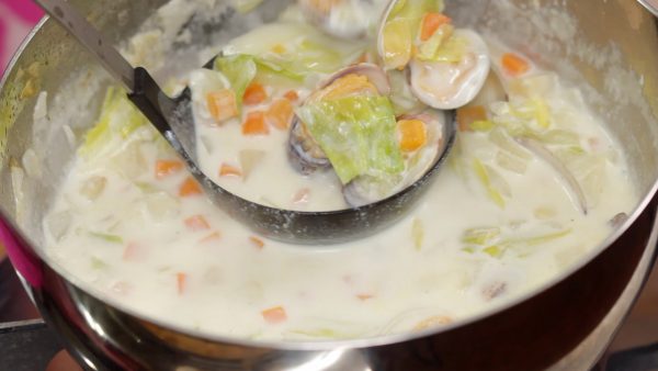 Ladle the clam chowder into a bowl.