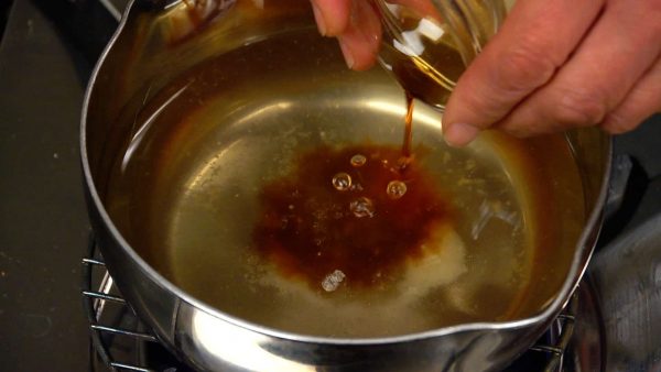 Now, heat the dashi stock in a pot. Add the salt, sake and soy sauce. Lightly stir the mixture.