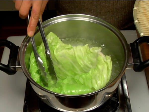 Now, let's make cabbage rolls. Cook the cabbage leaf in boiling water.