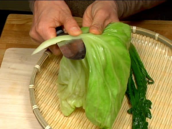 Remove the firm stalk of the cabbage leaf.