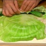 Place the spinach on the cabbage leaf and roll it tightly.