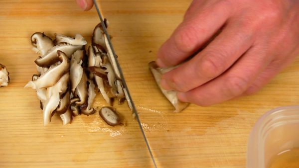 Remove the stems and slice the shiitake into the thinnest possible strips.