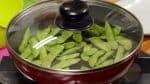 Cover and heat the pan on low heat. Cook the edamame for about 3 minutes until the water evaporates.
