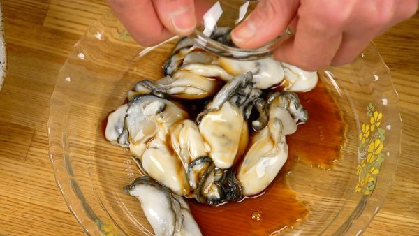 Now, add a small amount of ponzu sauce and toss to coat. This will help to keep the oysters from getting mushy.