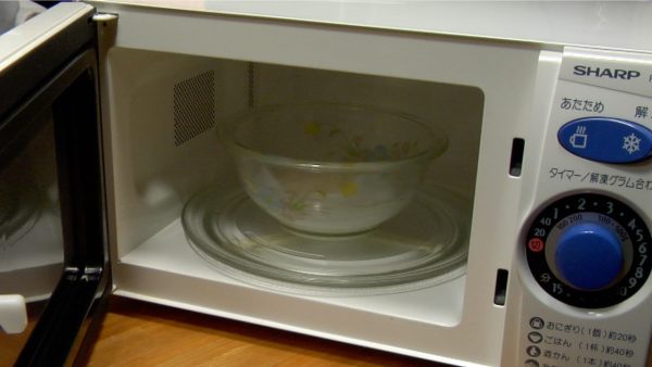 Put the bowl in the microwave and heat it for about 1 minute. The cooking time depends on the wattage of the microwave, and this microwave is cooking at 700 watts.