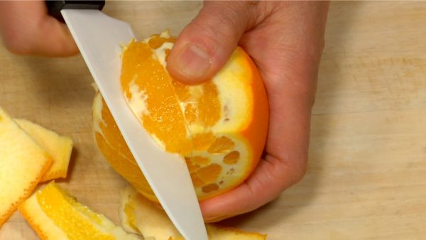 Make a V-shape cut into the center of the orange and remove the piece.