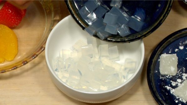 Let's serve the Fruit Cream Anmitsu. Put one third of Kanten cubes in the bowl.