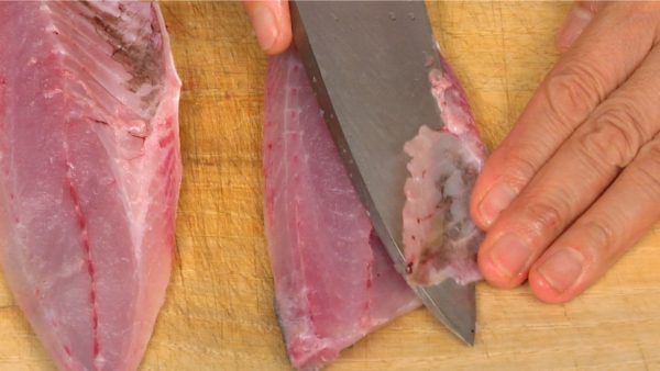 Make a shallow cut along the end of the rib bones and then shave them off.