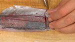 Using a long knife such as a sashimi knife, pull the blade across the fillet to cut it into bite-size pieces.