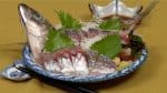 Rincez soigneusement la tête et la queue et placez-les à côté du sashimi comme garniture dramatique pour souligner la fraîcheur du plat.