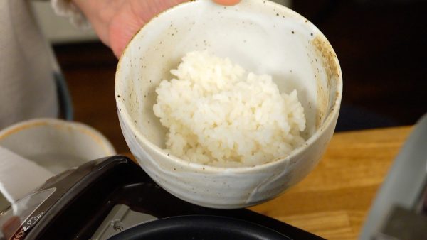 Now, place the fresh steamed rice into a bowl.