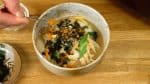 Top with the shredded nori seaweed. Finally, sprinkle on the shichimi, seven flavor chili powder to taste.