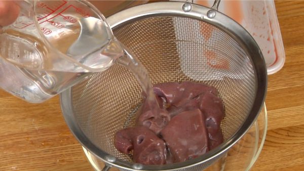 Now, remove the liver from the bowl, place it into a mesh strainer and lightly rinse with clean water.