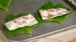 Now, place each fillet onto a shiso leaf in a tray.