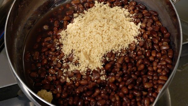 Reheat the beans and add one third of the sugar.