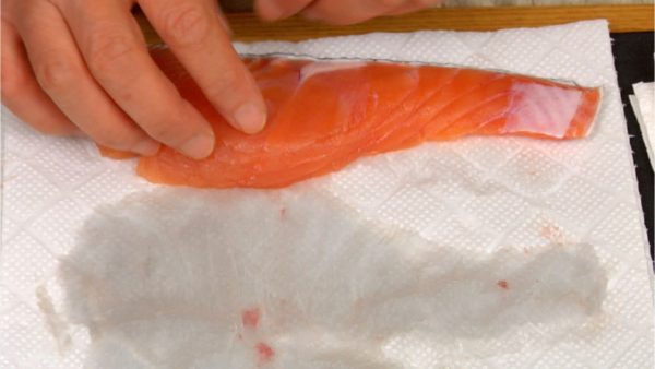 Remove the excess water and place the salmon onto a plate.