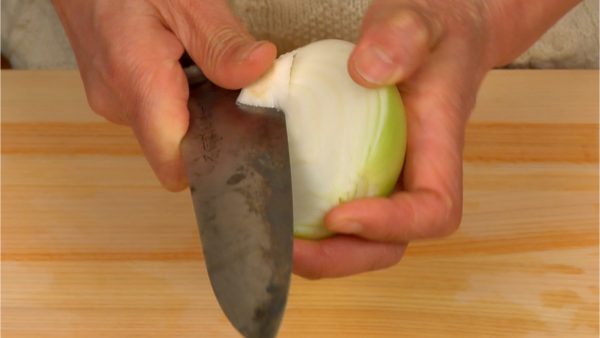 Remove the root end from the onion.