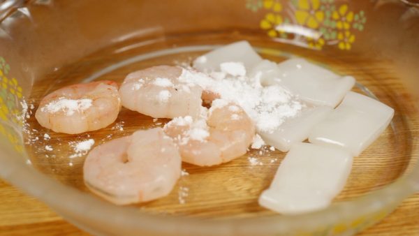 Jetzt werden die eigentlichen Zutaten vorbereitet. Aufgetaute Shrimps und Tintenfisch (gemeint sind etwas dickere Mantelstücke...keine Arme oder dergleichen) trockentupfen und anschließend mit Kartoffelmehl bestreuen und vermengen. Dies reduziert ein "fischiges" Aroma und eventuelle Sandreste o.dgl. werden gebundn.