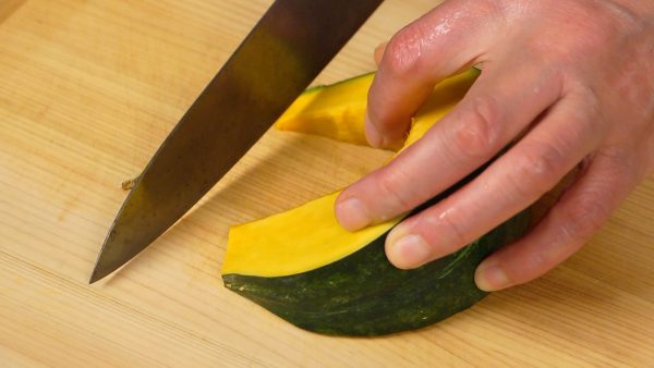 Next, trim off the stem end and the bottom of the kabocha squash.