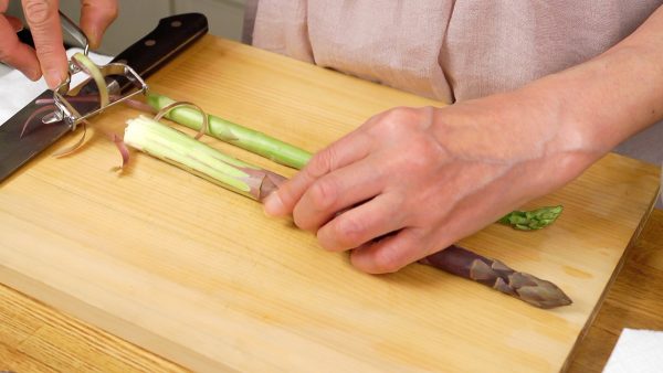 Peel the firm outer skin on the bottom third of the asparagus spears. Trim off the bottom ends.