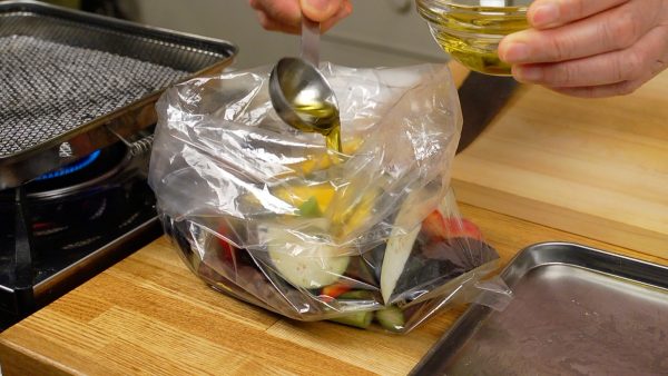 Add the olive oil or any type of vegetable oil. Then, shake the bag to coat the pieces with the oil evenly.