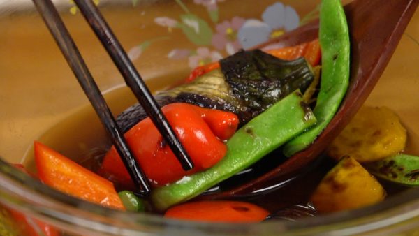 Now, place the vegetables into a bowl. Arrange the pieces in the bowl to make the dish more presentable. Pour a generous amount of the dashi sauce over the vegetables.