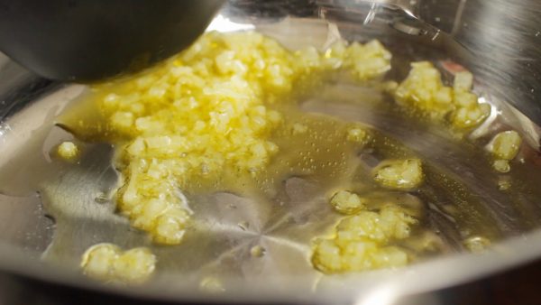 Turn on the burner and stir-fry the garlic on medium heat.