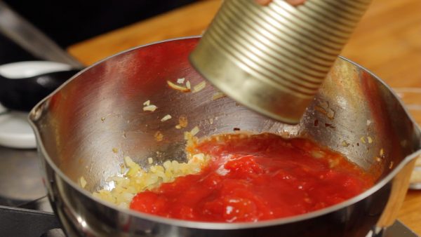 洋蔥稍微變棕色且香氣逐漸達到時，加入切好的罐頭番茄。