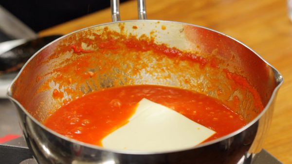 Add your favorite cheese to the sauce and melt it to distribute evenly.