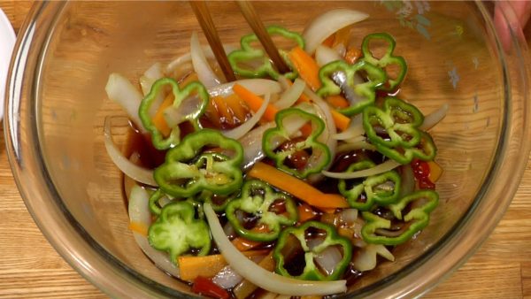 Add the bell peppers and submerge the vegetables in the vinegar sauce with a pair of kitchen chopsticks.