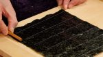 Next, we will show you how to cut the nori seaweed. Most rectangular sheets of nori have lines every 3.3cm (1.3") and this will be the height of the gunkanmaki.
