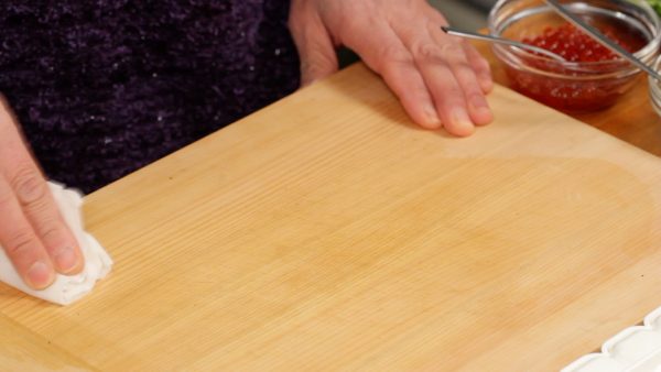 Now, clean off the cutting board with a slightly dampened towel to help avoid sticking.