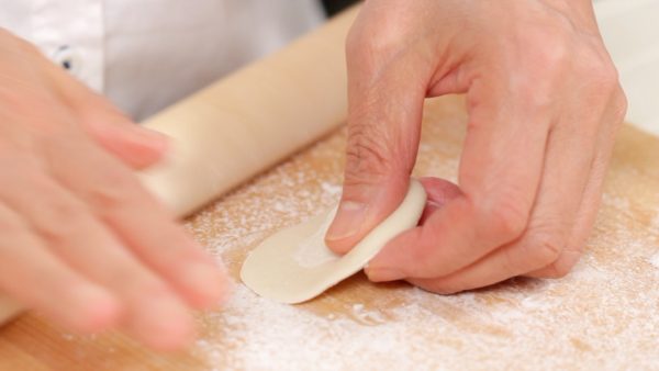 Then, press it into a thin flat circle using a rolling pin.
