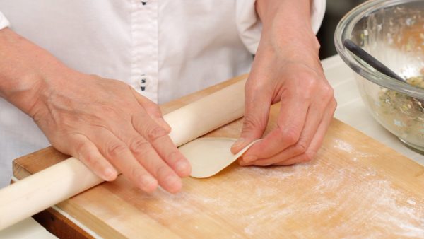 Roll the pin toward the center of the dough and back while slowly rotating it in a circle.
