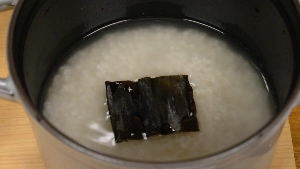 Pour the water into it. Then, add the kombu seaweed.