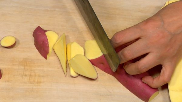 Cut the potato into rolling wedges while rotating it toward you.