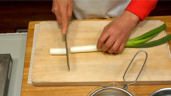 Let's cut the ingredients. Cut off a 5 cm (2") piece from the white part of the long green onion, naganegi