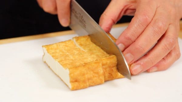 This is Atsuage, a type of thick deep-fried tofu. Cut it into 1.5 cm (0.6") bite-size pieces.