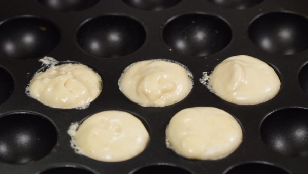 Then, place the batter into the molds. The heat should remain on low but this time, each mold should be completely full.