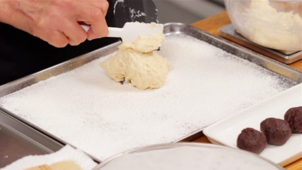 Measure half of the rested dough and transfer it to a tray covered with plenty of flour. We've accidentally rested this dough for a little longer than 30 minutes.