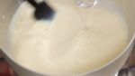 While quickly stirring the soy milk, add the nigari coagulant. Be careful not to over-mix the mixture otherwise the tofu will not have a smooth texture.